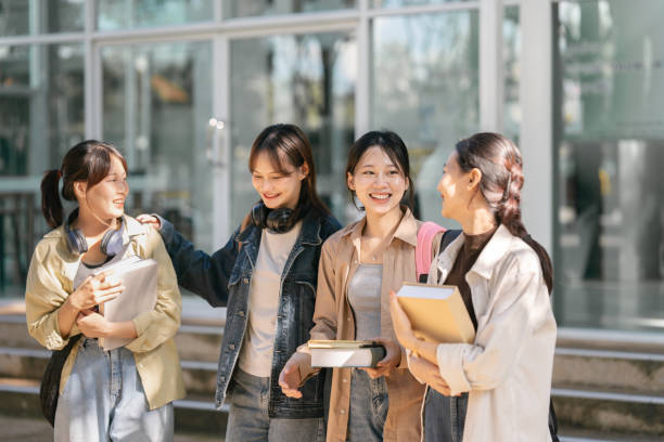 Group of Young Asian student walking and talking at university before class room. education, back to school concept