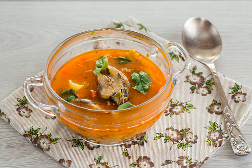 vegetable tomato soup with fish in a plate