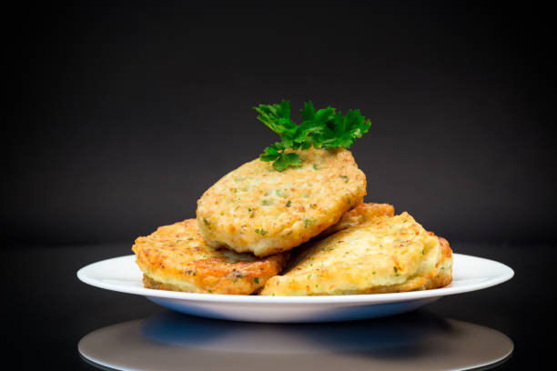 cooked fried potato cutlets with herbs stock photo