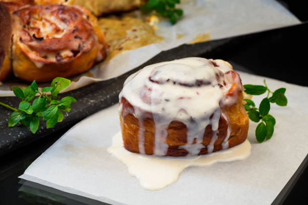 istock cooked baked sweet Cinnabon with cream in baking paper . 1856956800