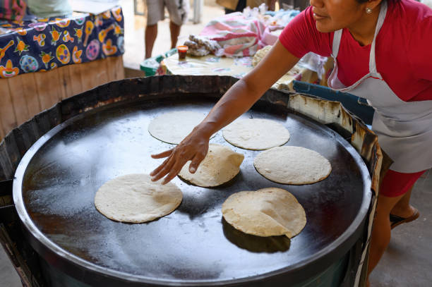 istock Woman cooking delicious corn tortillas 1856991471