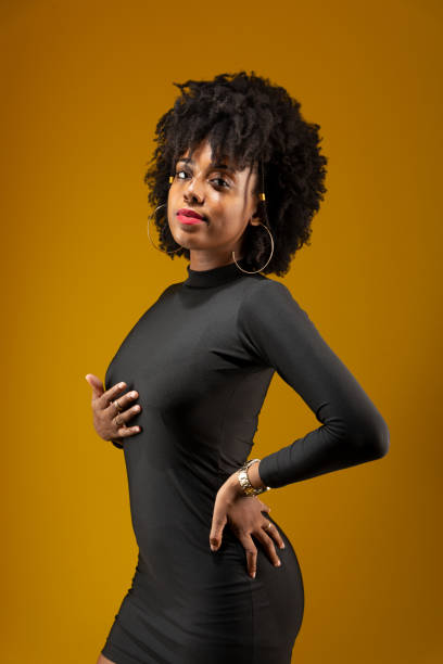istock Young woman standing, wearing black clothes and posing for a photo. 1857007607