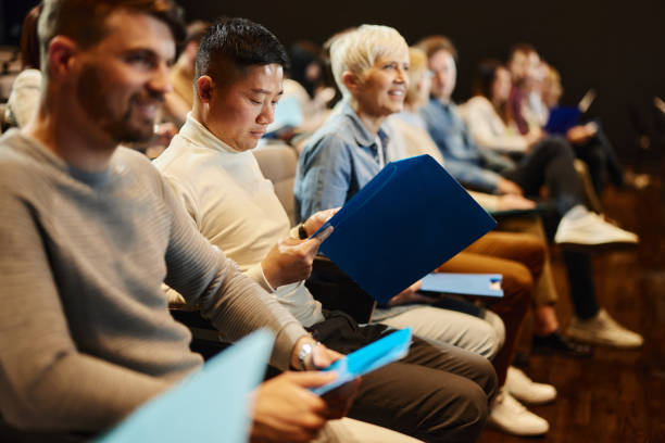 istock Asian man reading documents while attending a seminar in convention center. 1857027066