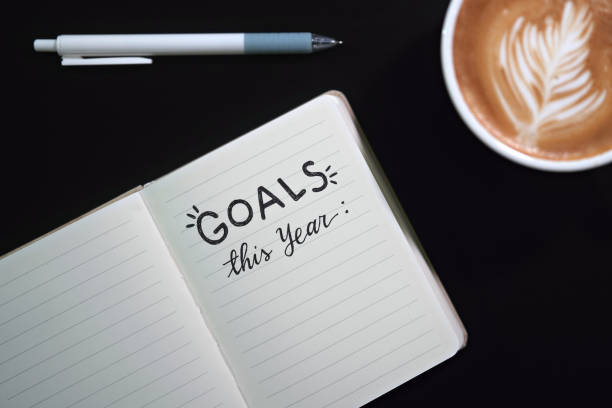 istock 'GOALS this year' text on notebook, planning on New Year's Resolutions, coffee cup on desk 1857035049