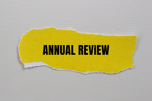 Annual review lettering on ripped paper. Business concept photo.