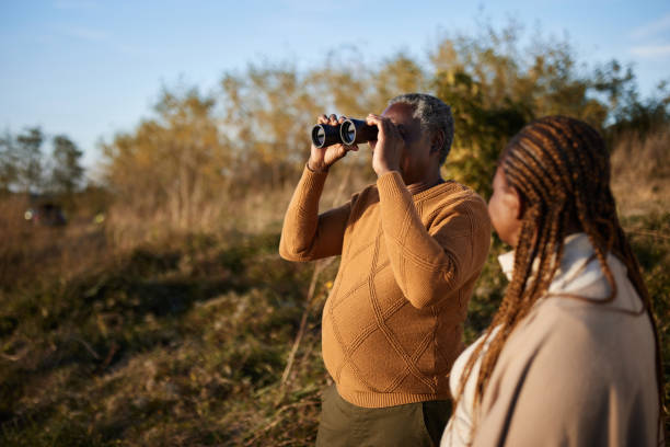 istock Black senior man using binoculars with his wife in autumn day. 1857051347