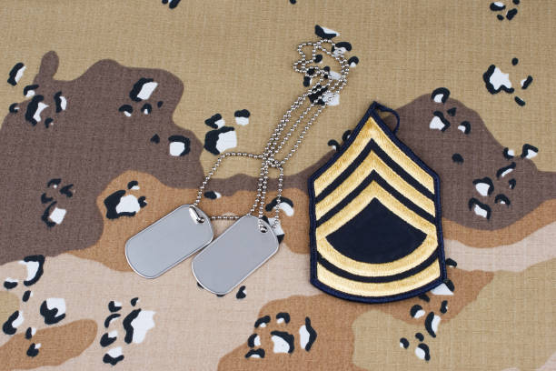 istock US ARMY Sergeant First Class rank patch and dog tags on Desert Battle Dress Uniform background 1857064332