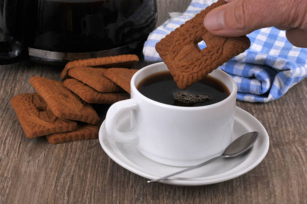 Eat speculoos for breakfast Dipped speculoos in a cup of coffee close-up tasse café stock pictures, royalty-free photos & images