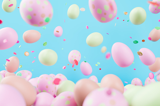 Pastel Easter Eggs and Confetti in Festive Celebration on Blue Background