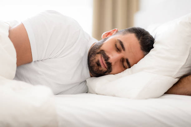 istock Peaceful millennial man deeply asleep napping in domestic bedroom 1857087047