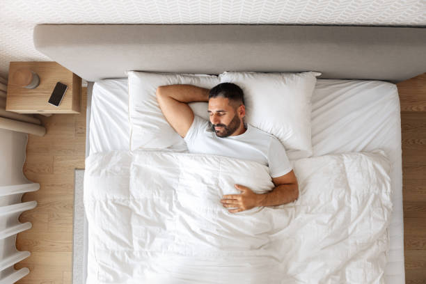 istock Top view of sleeping guy enjoying restful nap in bedroom 1857087069