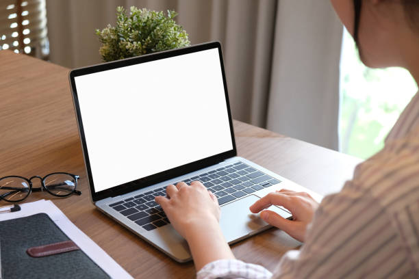 istock Woman using laptop with blank copy space screen for your advertisement. on the table in office 1857087324