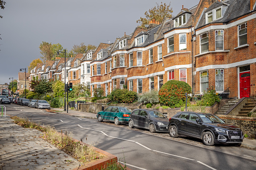 London, UK - 25 October 2020: Car and motorcycle waiting at crossroads in Fulham