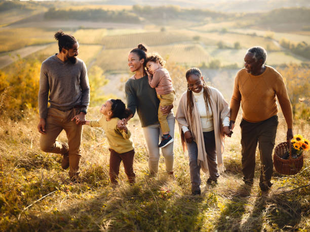 istock Happy black extended family talking while going on a picnic up the hill. 1857099009