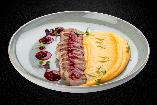 istock Duck breast, with pumpkin puree, cherry sauce and peanuts. Isolated image 1857113096
