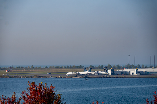 Airport over Lake Ontario from Toronto , Ontario, Canada on a bright Autumn day with a cloudless sky.