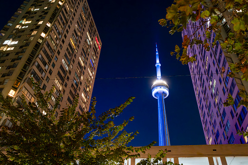 The CN Tower in Toronto, Ontario, Canada on a bright Autumn night with a cloudless night sky.