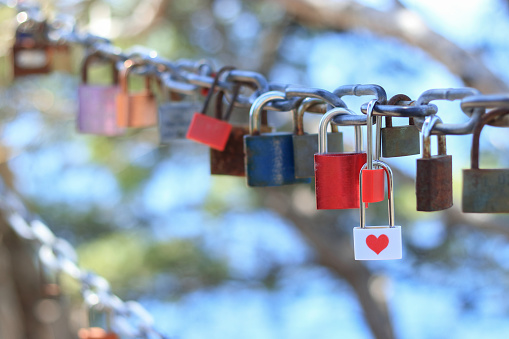 Gold heart shaped Padlock on a bridge, romantic but a lot of trouble for the bridgeowner