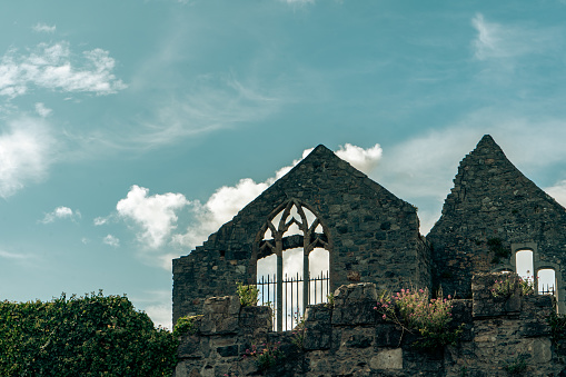 Ivy-covered church ruins with cloudy sky