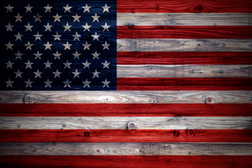 USA flag on a weathered natural wooden wall close-up