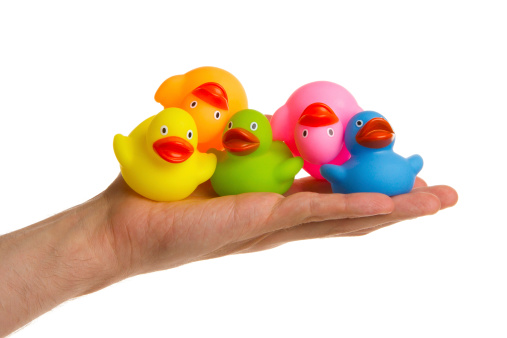 Rubber ducks isolated on a adults hand