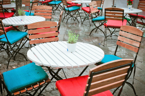 Tables and chairs outside in the rain