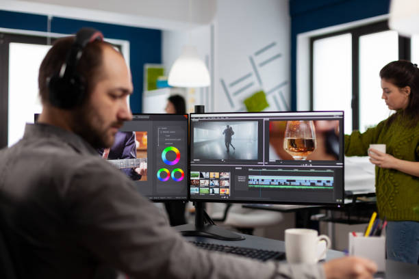 istock Videographer with headset working with footage and sound on pc 1857181531