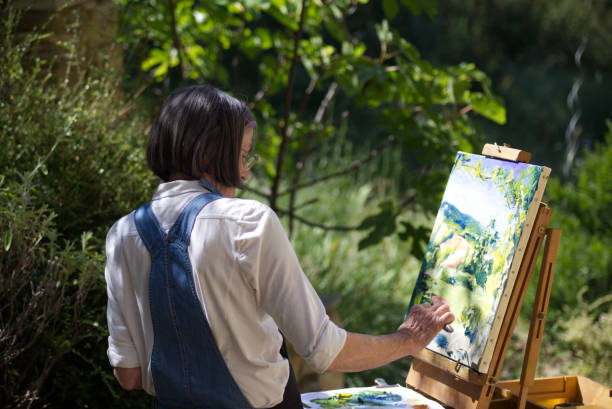 istock Woman painting at an easel 1857196027