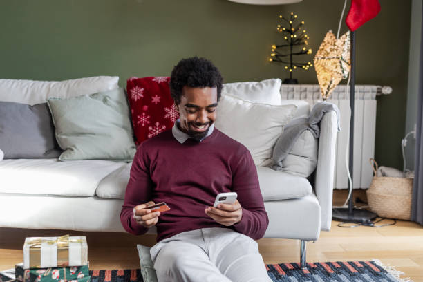 istock Young man shopping online during Christmas Holidays 1857198715