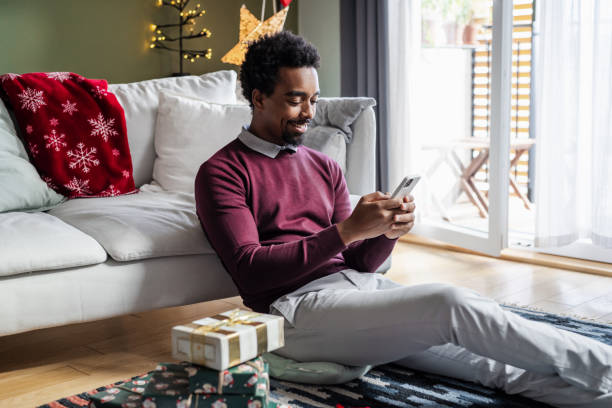 istock Young African American man staying connected during Holidays 1857198717