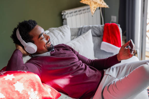istock Young man watching videos on the phone during Holidays 1857199232