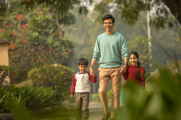 istock Father with children enjoying in park 1857207777