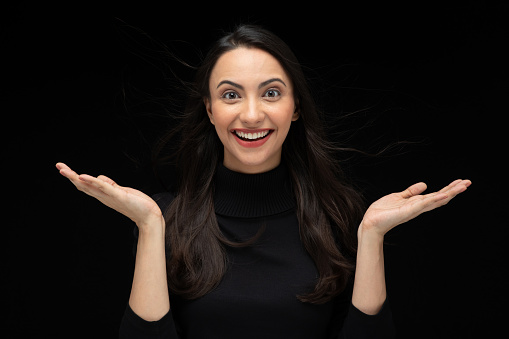 Photo of beautiful amazed girl wearing casual black t-shirt isolated black background