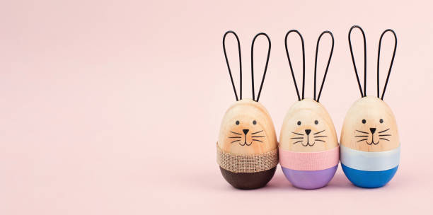 istock Easter bunny or rabbit group, holiday background and greeting card, painted wooden egg 1857224158