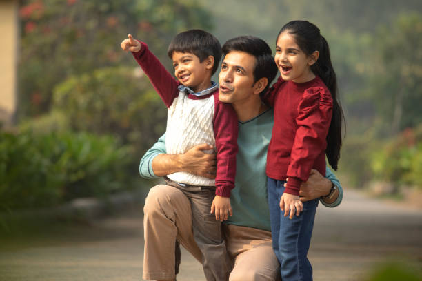 istock Father and children having fun in garden 1857232012