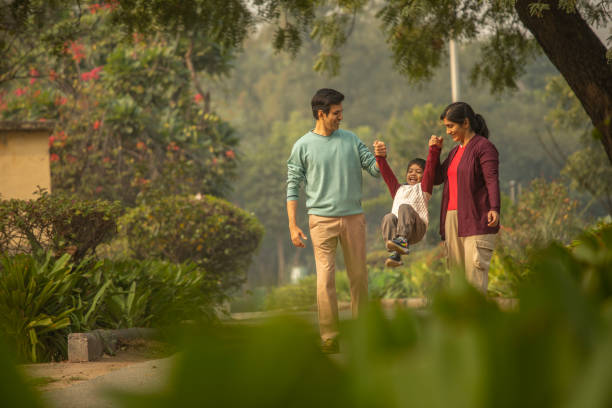 istock Happy parents and son playing in park 1857233573