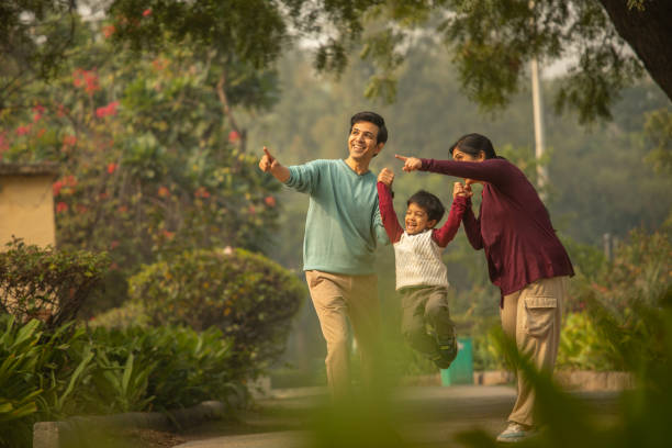 istock Happy parents and son looking away in park 1857234096