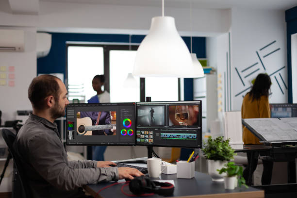 istock Video editor cuting footage working at film editing montage on computer with dual monitors setup 1857235151