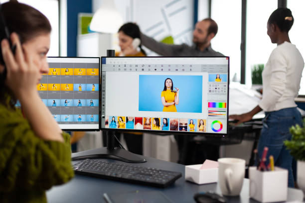 istock Retoucher woman working on computer with two monitors and stylus pencil 1857240392