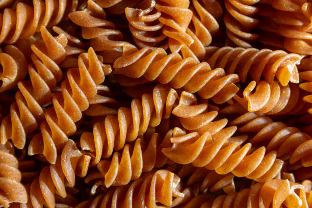 istock Uncooked Whole Grain Fusilli Pasta Background 1857246821