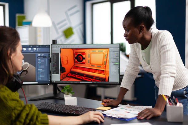 istock Multiethnic women designer looking at computer with dual displays 1857247353