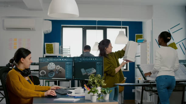 istock Industrial engineer putting on headset working at pc with two monitors 1857249510