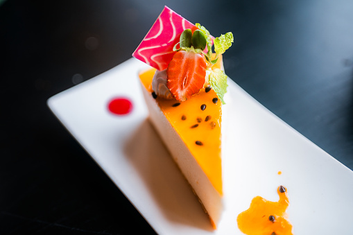 Passion fruit cheesecake on a plate.