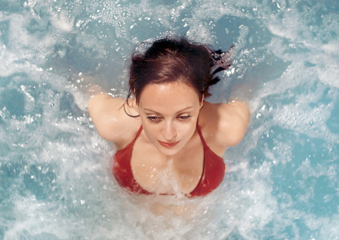 Top view of woman relaxing in hot tub