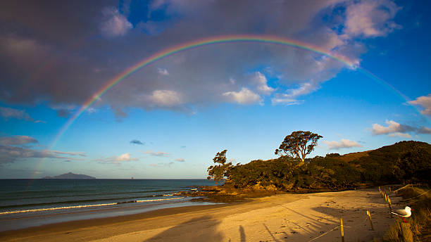 Rainbow over beach stock photo