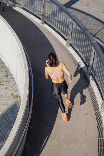 istock High angle view on active woman running on the curved elevated walkway 1857272942