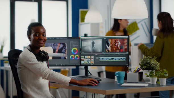 istock African video editor looking at camera smiling editing video project 1857274535