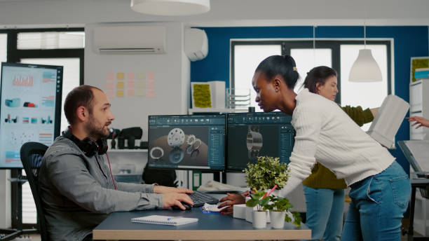 istock African project manager coming at technician designer discussing 1857275061