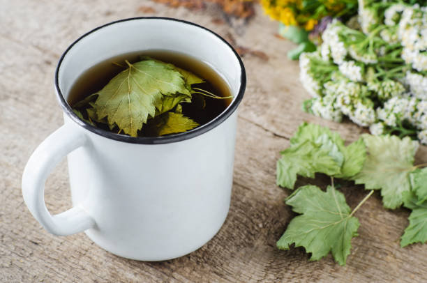 istock Mug with herbal tea (infusion) with dried black currant leaves. Close-up, copy space. 1857278754