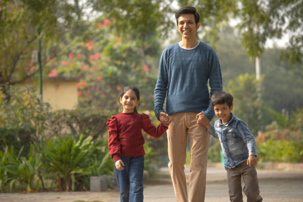 istock Father with children enjoying in park 1857284142